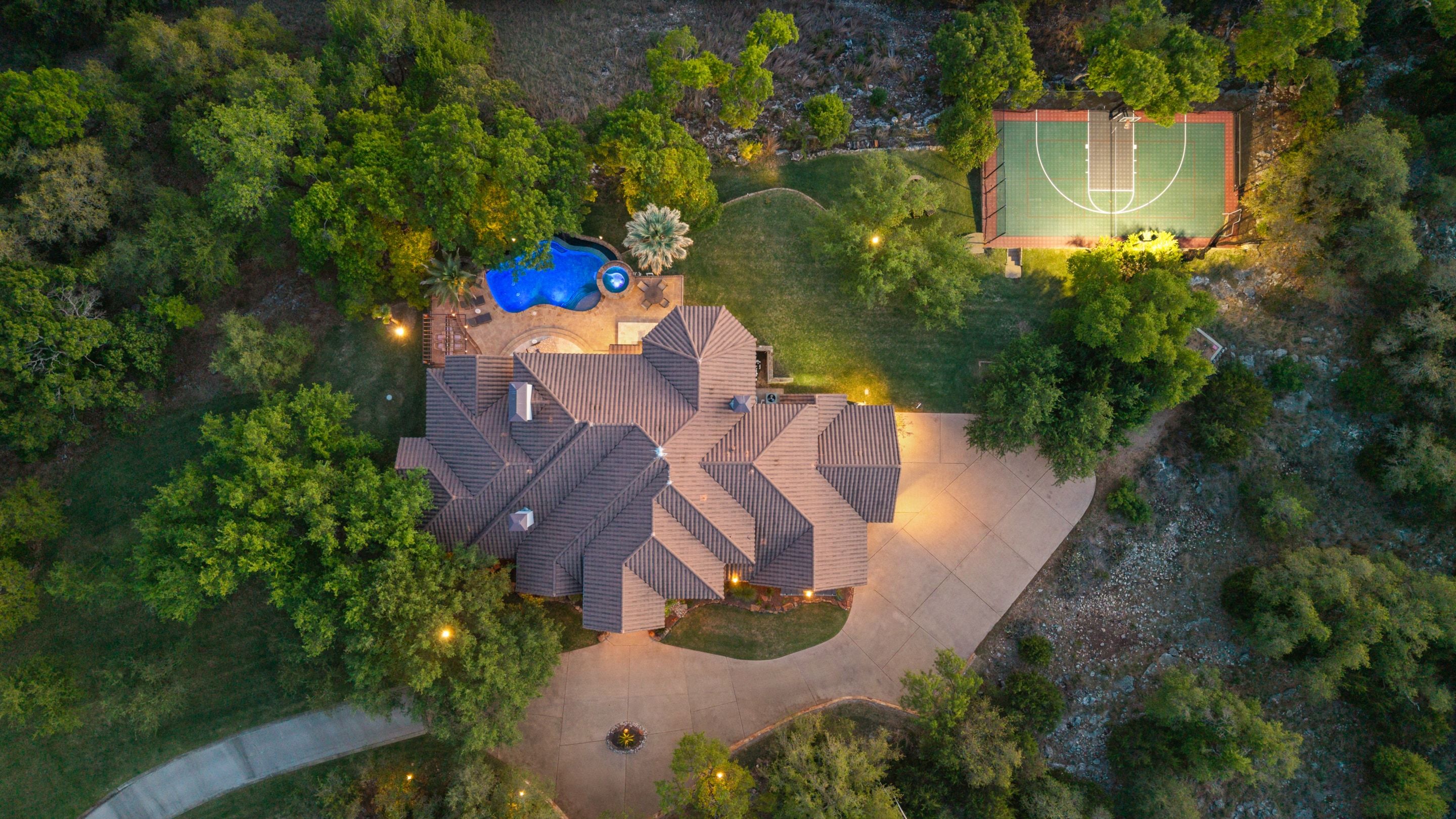 Lakehaven aerial showing the residence, pool terrace, and sport court in Georgetown, Texas