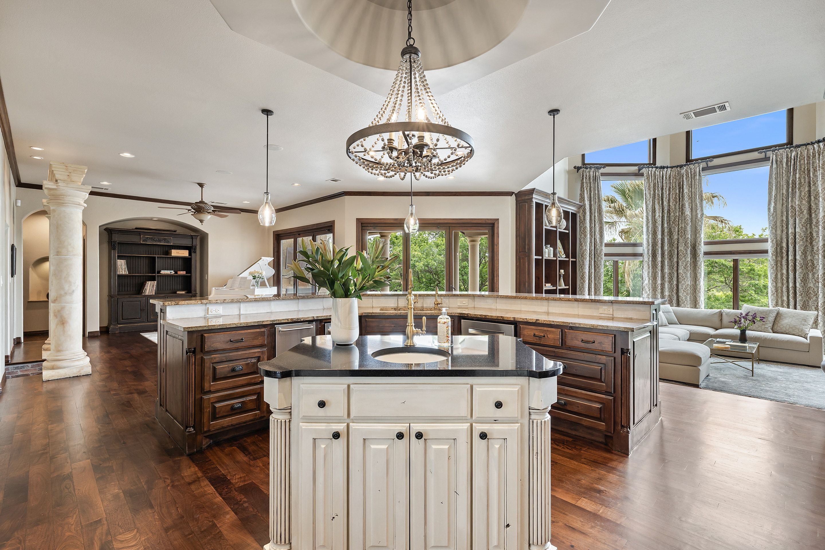 Main living room at Lakehaven opening toward the kitchen and fireplace wall