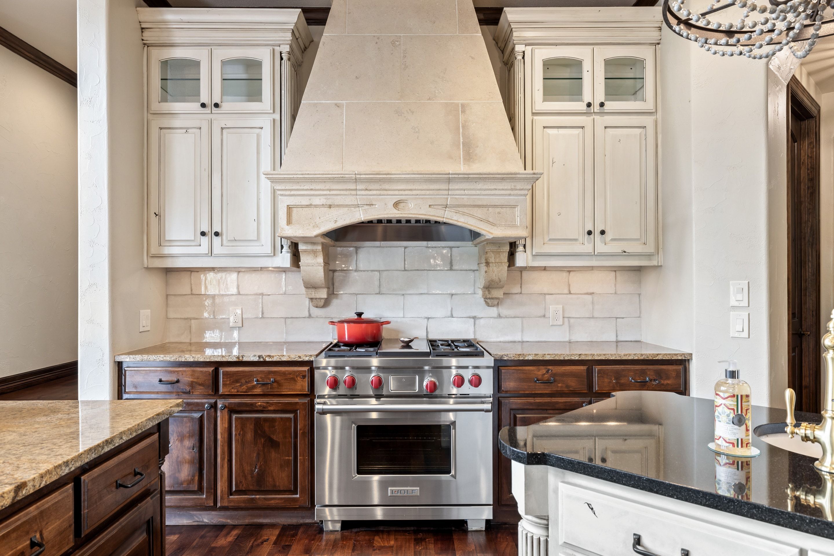 Kitchen range wall at Lakehaven with custom cabinetry and stone finishes