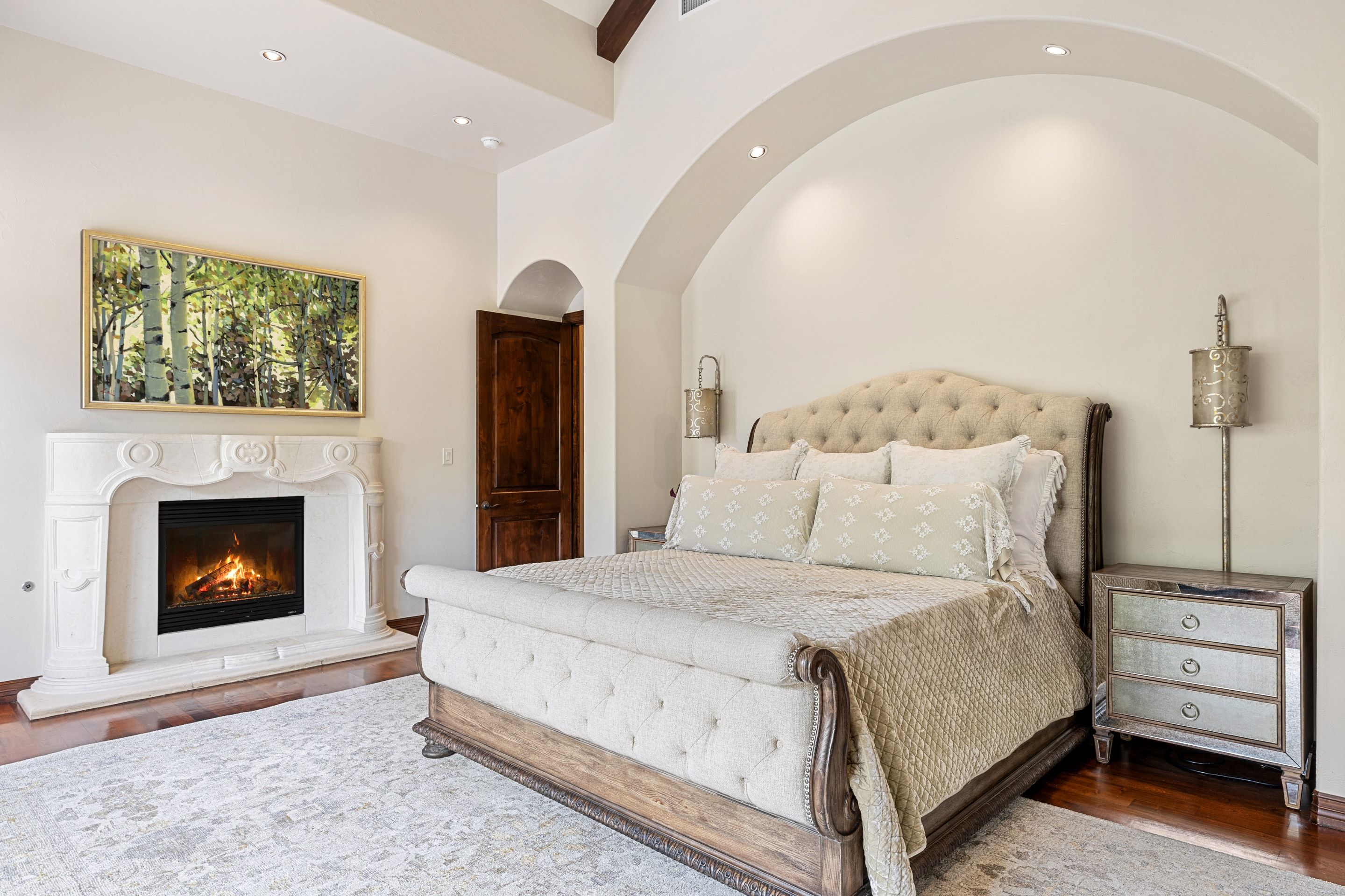 Guest bedroom at Lakehaven with a fireplace and arched alcove