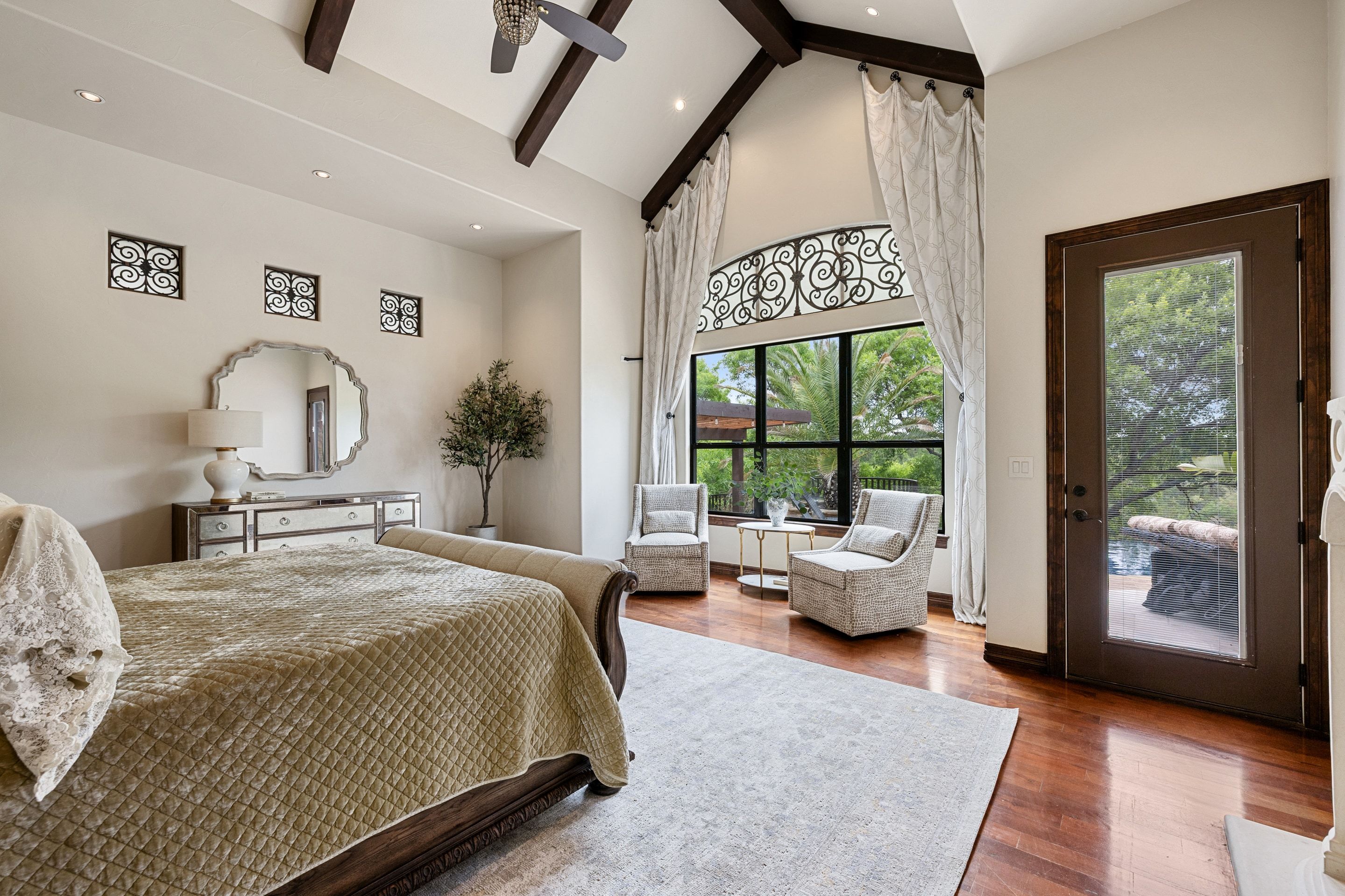 Primary suite at Lakehaven with a fireplace, sitting area, and access to the outdoor terrace