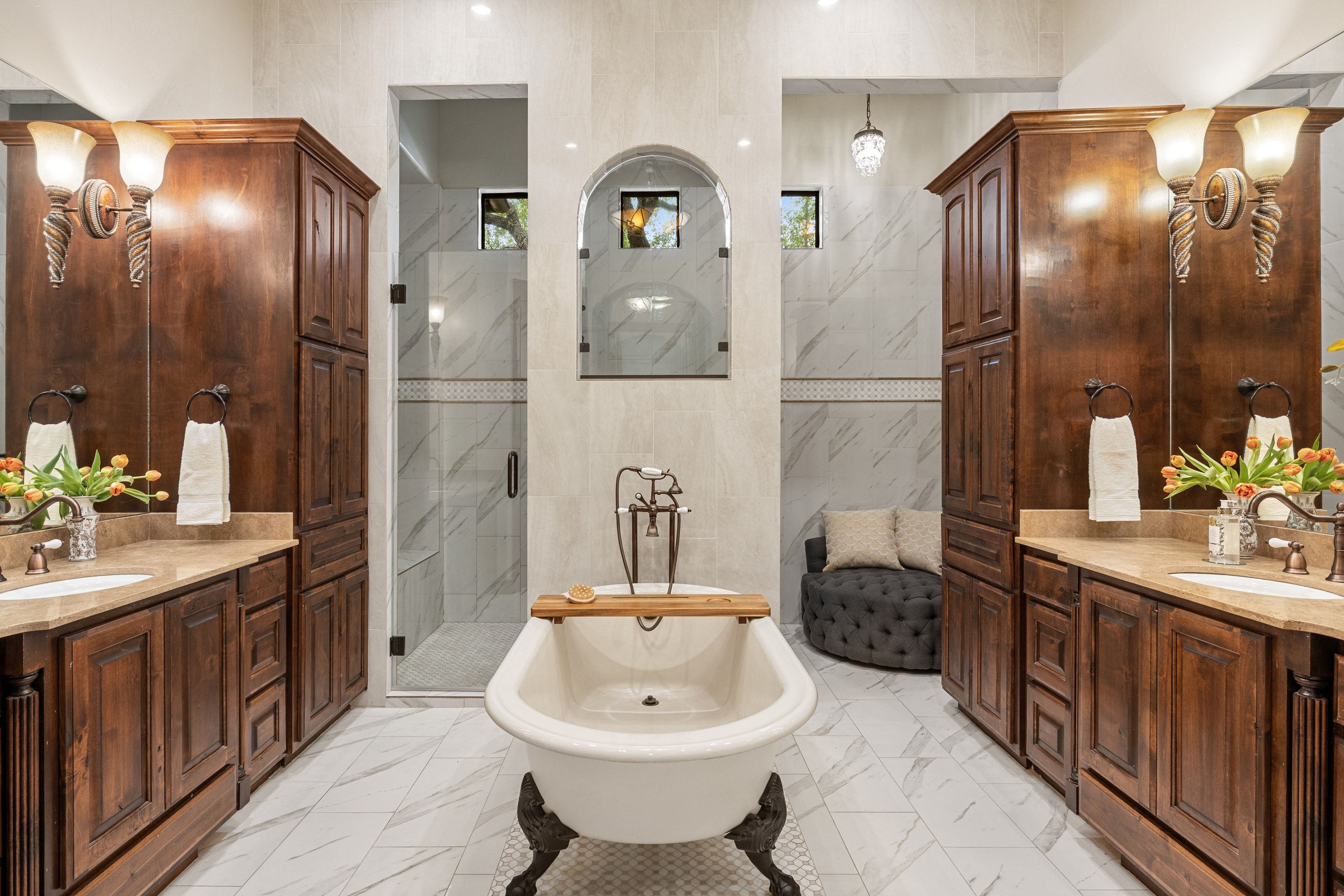 Primary bathroom at Lakehaven with a freestanding tub, dual vanities, and updated tile