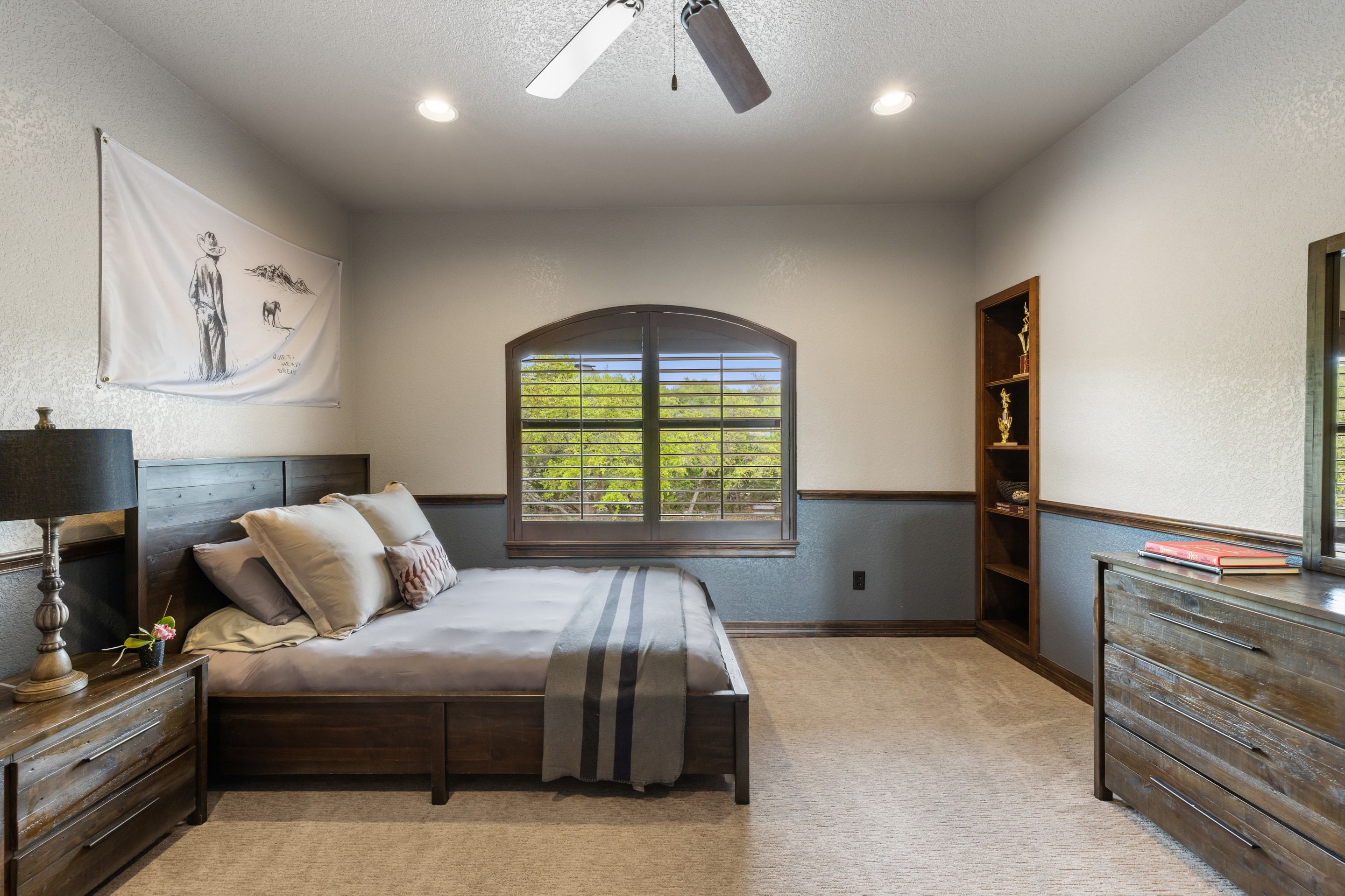 Secondary bedroom at Lakehaven with built-ins and an arched window