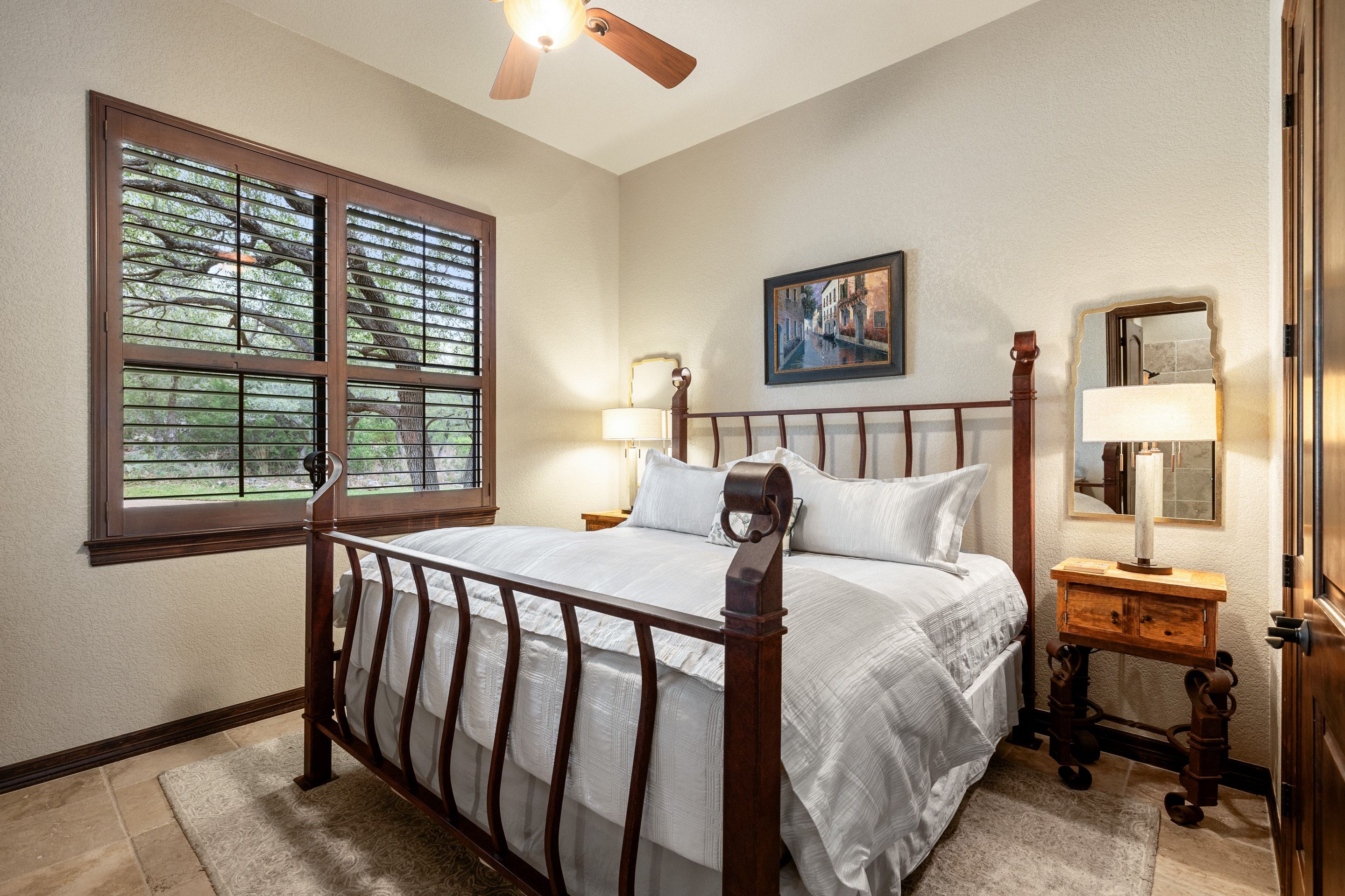 Guest bedroom at Lakehaven with warm natural light and garden outlooks