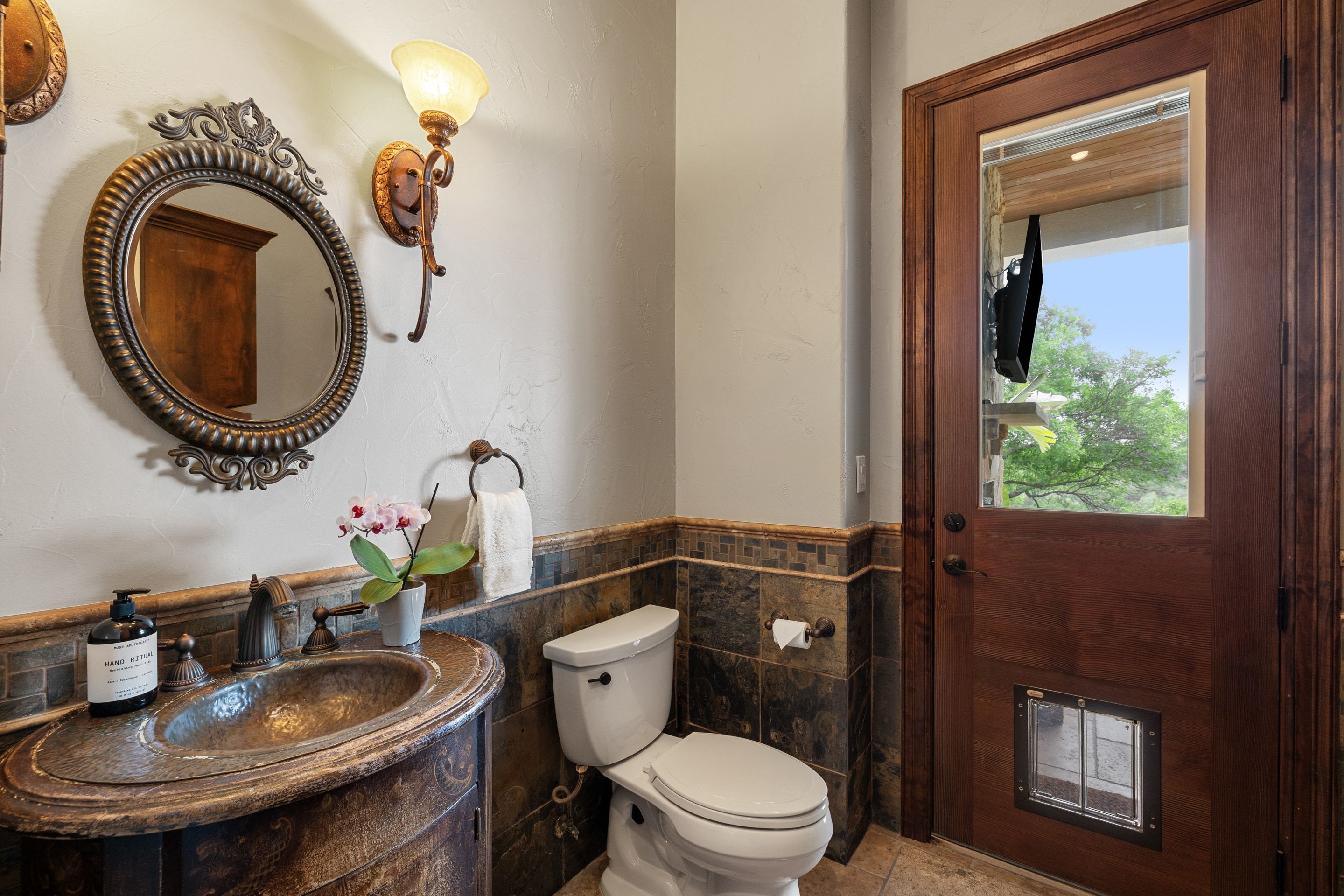 Pool-access powder bath at Lakehaven with an exterior door and updated fixtures