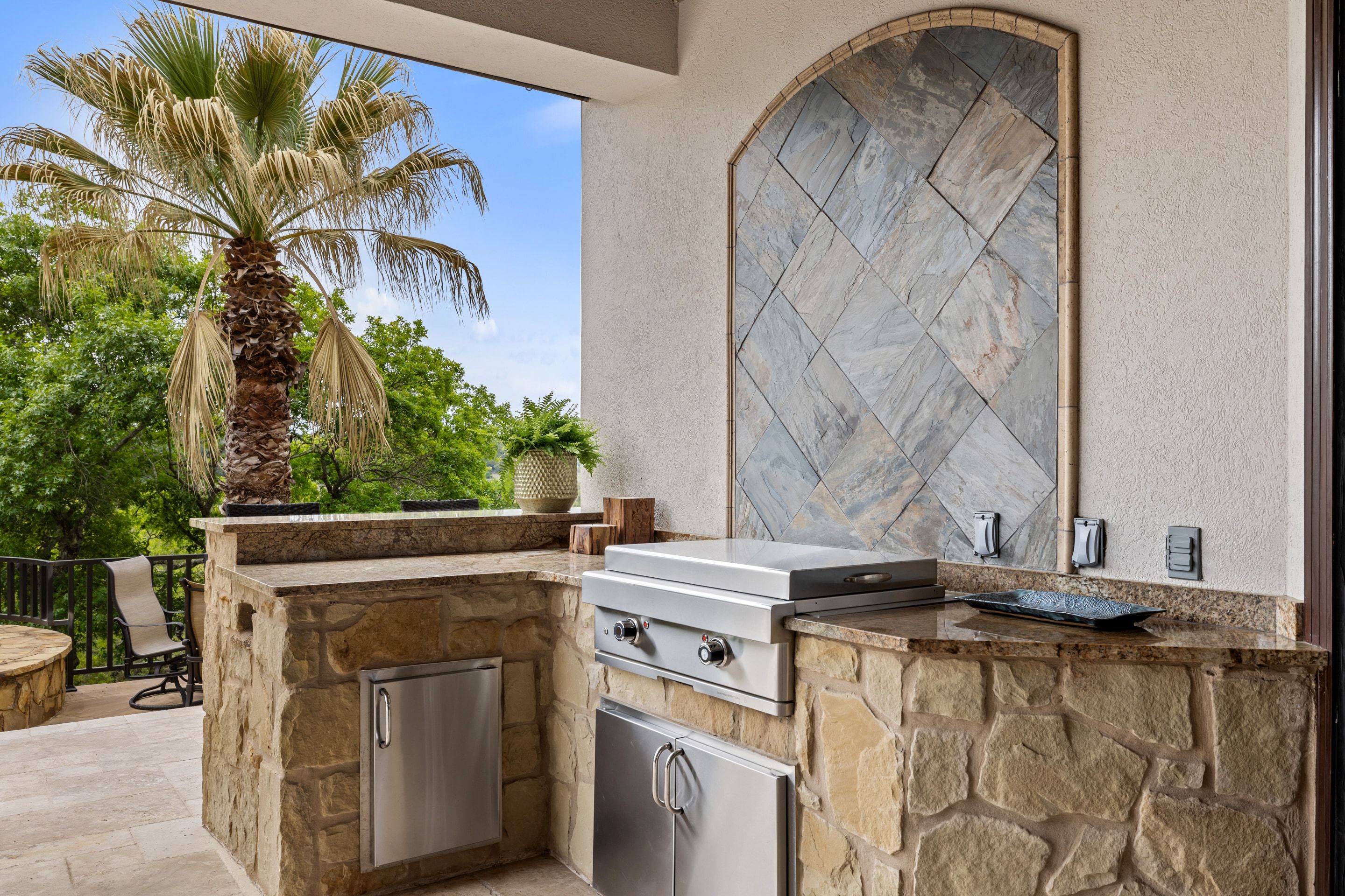 Outdoor kitchen at Lakehaven with stone detailing and grilling station