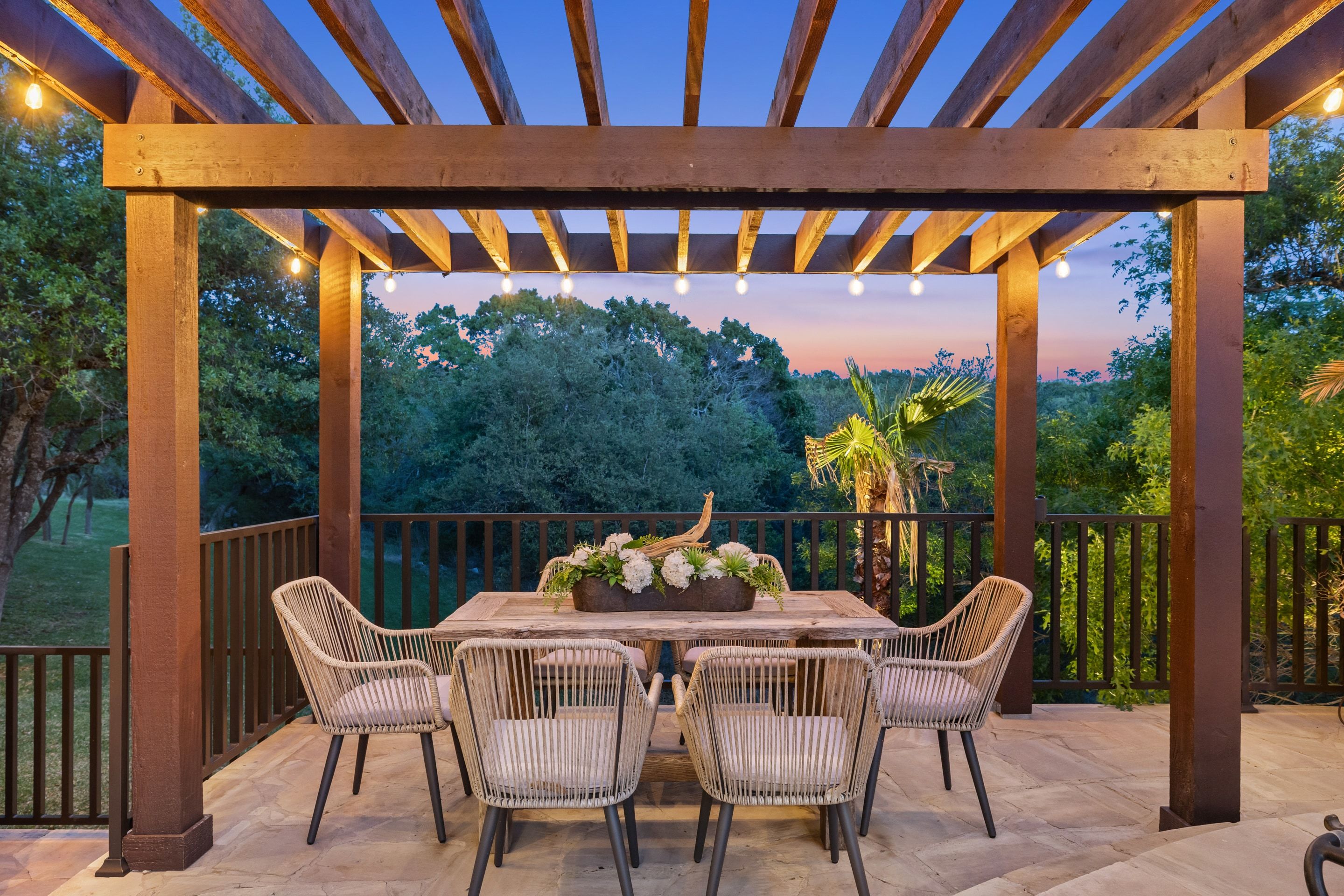 Pergola dining terrace at Lakehaven with festoon lighting at dusk