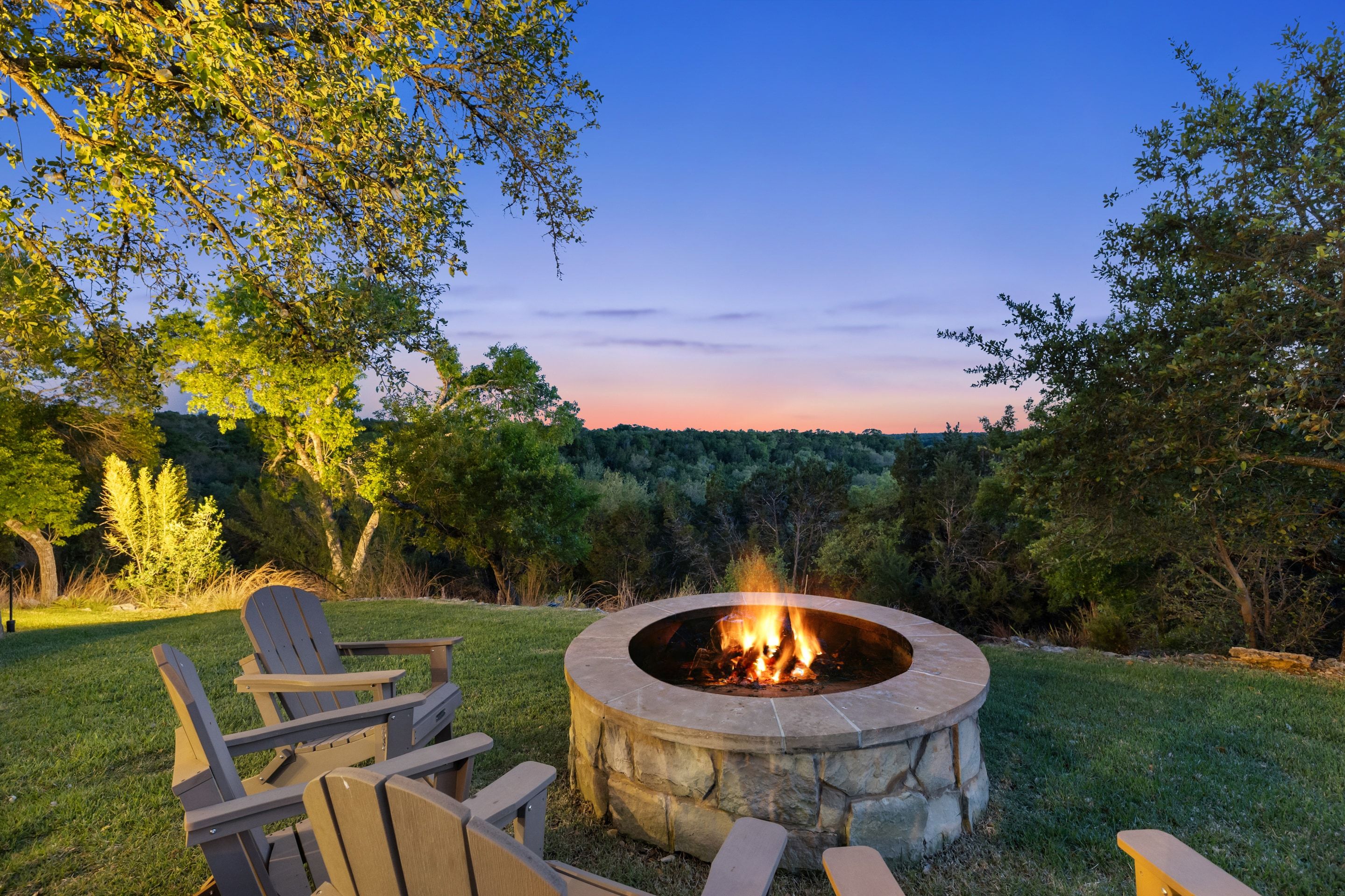 Fire pit terrace at Lakehaven looking across the tree canopy at dusk